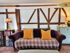 a purple couch with orange pillows in a living room at 3 Bed in Salcombe 75138 in Bigbury