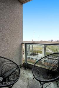 two metal chairs sitting on a balcony with a view at DownTown Toronto luxury condo in Toronto