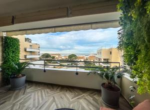 a balcony with plants and a view of a city at L’Escale Borely in Marseille