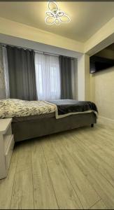 1 dormitorio con 1 cama y ventilador de techo en AIRPORT-TAXI-PARKING-Card, en Chişinău
