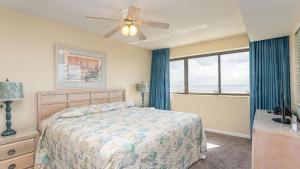 a bedroom with a bed and a ceiling fan at Ocean Bay Club 101 - Oceanfront - Ocean Drive Section in Myrtle Beach +24 photos