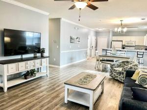 a living room with a large flat screen tv at Barefoot Beach Haven: Resort Access in North Myrtle Beach