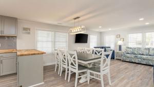 a kitchen and dining room with a table and chairs at Sand Dollar - 3rd Row - Ocean Drive Section in Myrtle Beach