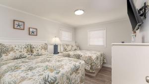 a bedroom with a bed and a couch at Sand Dollar - 3rd Row - Ocean Drive Section in Myrtle Beach +22 photos