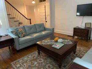 a living room with a couch and a coffee table at Madison Manor II by the River Hot Tub Downtown in Madison