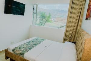 Postel nebo postele na pokoji v ubytování Hotel Central Plaza Medellin