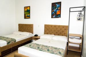 Postel nebo postele na pokoji v ubytování Hotel Central Plaza Medellin