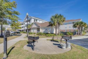 a park with benches and a street sign and a building at Barefoot Resort - Cypress Bend 123 - Windy Hill in North Myrtle Beach