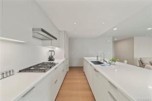 a kitchen with white counters and a stove top oven at Park lane 2/2 in Honolulu