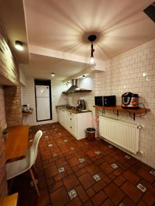 cocina con suelo de baldosa, mesa y barra en Hotel Classic Corner en Tiflis