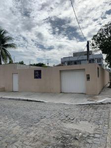 a building with two garage doors on the side of it at Casa Porto in Porto De Galinhas