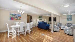 a dining room and living room with a table and chairs at Blue Moon - 3rd Row - Ocean Drive Section in Myrtle Beach