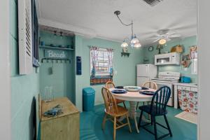 a kitchen with a table and chairs in a room at Barefoot Turtle - 3rd Row - Cherry Grove Section in Myrtle Beach