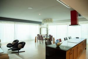 a kitchen and dining room with a table and chairs at Luxury Condo Peninsula in Puerto Vallarta