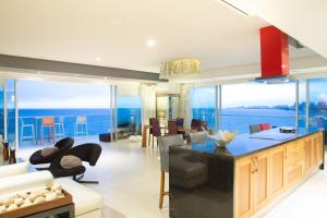 a kitchen and living room with a view of the ocean at Luxury Condo Peninsula in Puerto Vallarta