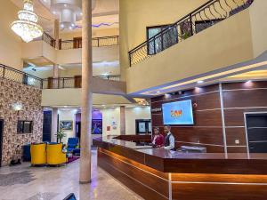 two people standing at a waiting area in a lobby at Parkview Astoria Hotel in Lagos