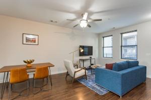 a living room with a blue couch and a table at TWO CozySuites Stylish Music Row Condos w parking in Nashville