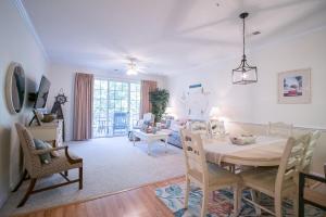 a dining room and living room with a table and chairs at Barefoot Resort - Arbor Trace 523 - Windy Hill in North Myrtle Beach