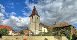 a church with a steeple on top of a building at Tiny House - Home-One in Dannemarie-sur-Crête