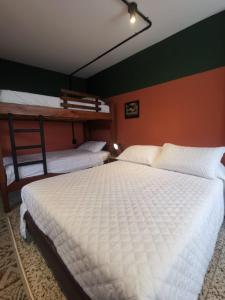 two beds in a room with two bunk beds at La Bonita Guesthouse in Bucaramanga