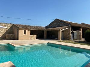 a large swimming pool in front of a house at Mas Gardane in Pernes-les-Fontaines