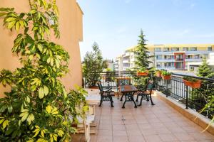 a patio with chairs and a table on a balcony at Family hotel Deykin in Sunny Beach