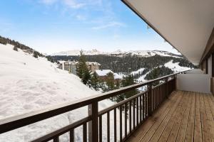 a balcony with a view of snow covered mountains at Residence - Pièces 134 in Courchevel