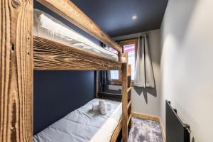 a bedroom with two bunk beds in a room at Residence - Pièces 134 in Courchevel