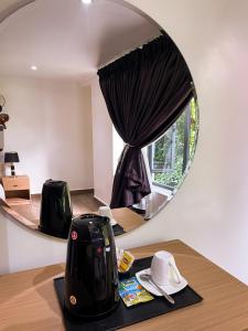 a mirror sitting on top of a table with a toaster at Address hotel and towers Abuja in Abuja