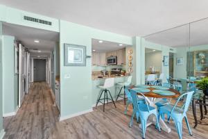 a kitchen and dining room with a table and chairs at Ocean Creek Resort E8 -Oceanfront - Windy Hill in Myrtle Beach