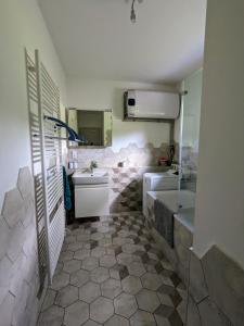 a bathroom with a sink and a toilet and a tub at Orlov - Brána do lesa in Příbram