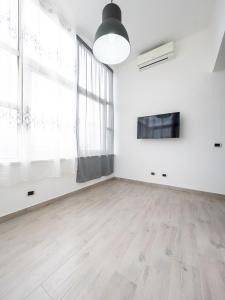 an empty room with white walls and a large window at INCANTO Apartament in Naples