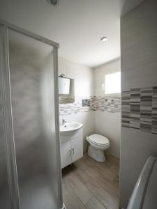 a bathroom with a toilet and a sink at INCANTO Apartament in Naples
