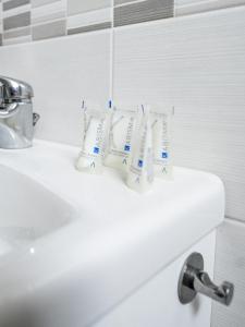 a bathroom sink with two toothbrushes on it at INCANTO Apartament in Naples