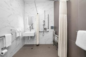 a white bathroom with a sink and a shower at Hotel 32One in San Francisco