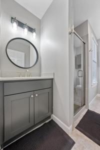 a bathroom with a sink and a mirror at Housepitality - The Village Sanctuary - Location in Columbus