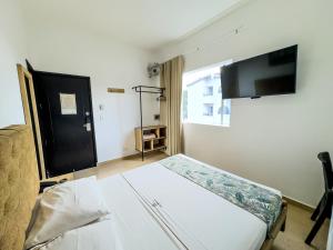 Postel nebo postele na pokoji v ubytování Hotel Central Plaza Medellin
