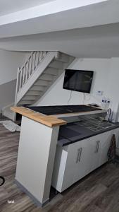 a room with a staircase and a desk with a computer at maison pas loin centre-ville in Reims
