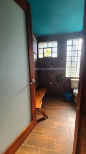 a room with a bathroom with a toilet and a window at Mar de Fondo in Puerto Escondido