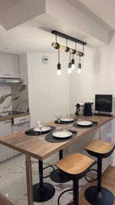 a kitchen with a table with plates on it at Appartement 5min to DisneyLand, parking privé in Magny-le-Hongre