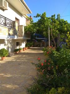 a courtyard of a building with plants and flowers at Villa Sunset in Samos