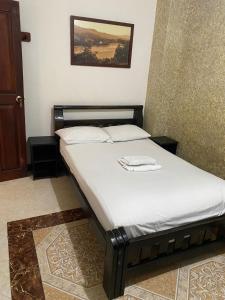 un piccolo letto in una camera con di CASA MORALES a Santa Fe de Antioquia
