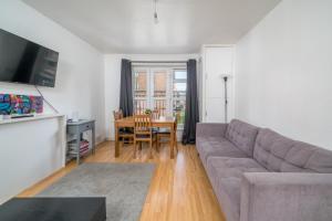 a living room with a couch and a table at Spacious 1 Bed Flat in Dalston in London
