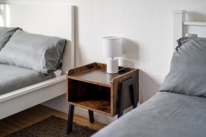 a table with a lamp on it next to a bed at Spacious 1 Bed Flat in Dalston in London