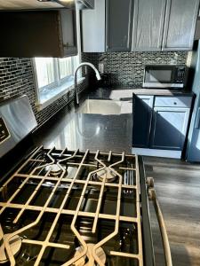 a kitchen with a stove top oven in a kitchen at Iron Bound Gem in Newark