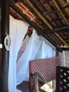 a bedroom in a house with a mosquito net at Villa Sowilo in Trancoso