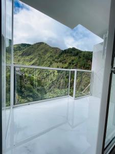 a room with a window with a mountain view at Hostal Balcon del Cielo in Baños