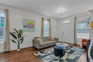 a living room with a couch and a table at Housepitality - The Columbus Game House - 2 BR in Columbus