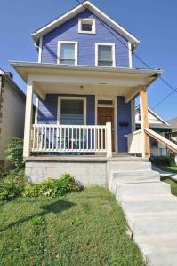 a blue house with a white porch and stairs at Housepitality - The Columbus Game House - 2 BR in Columbus