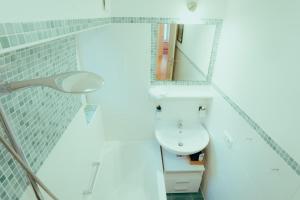 パッサウにある*Zentrumsnahe Wohlfühl-2-Zimmer-Wohnung*の洗面台と鏡のあるバスルーム